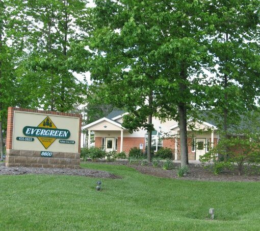 Evergreen Veterinary Hospital entrance sign with brick building and large trees in Centerville, Ohio