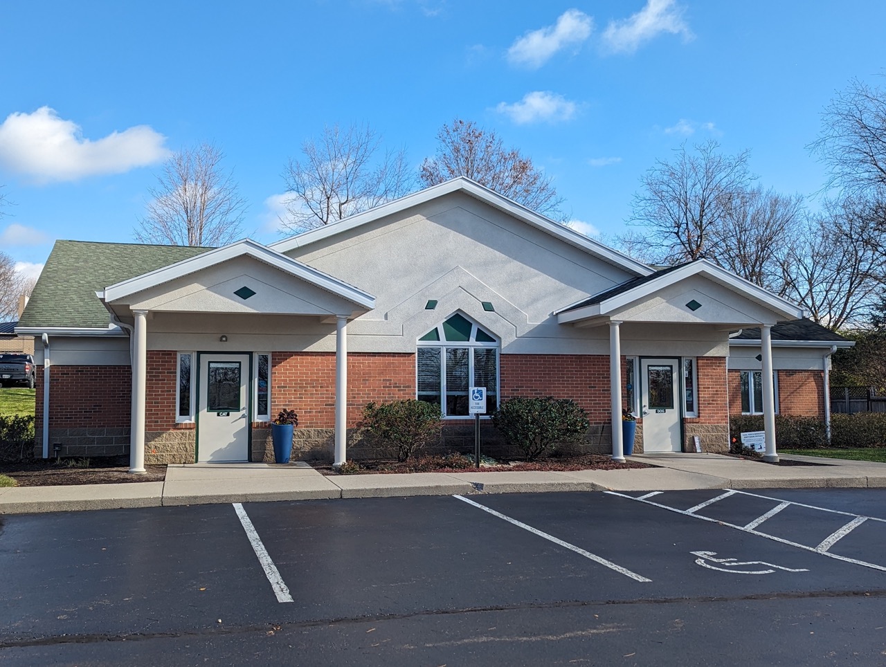 Modern brick veterinary clinic building in Centerville Ohio with covered entrance, accessible parking spaces, and professional medical facility design